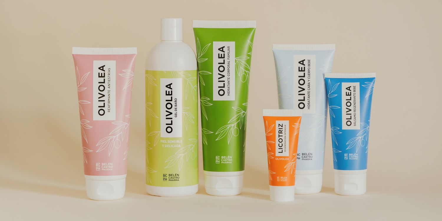 Productos cosméticos Olivolea sobre fondo beige, envases de colores pastel, cuidado de la piel y beneficios específicos.