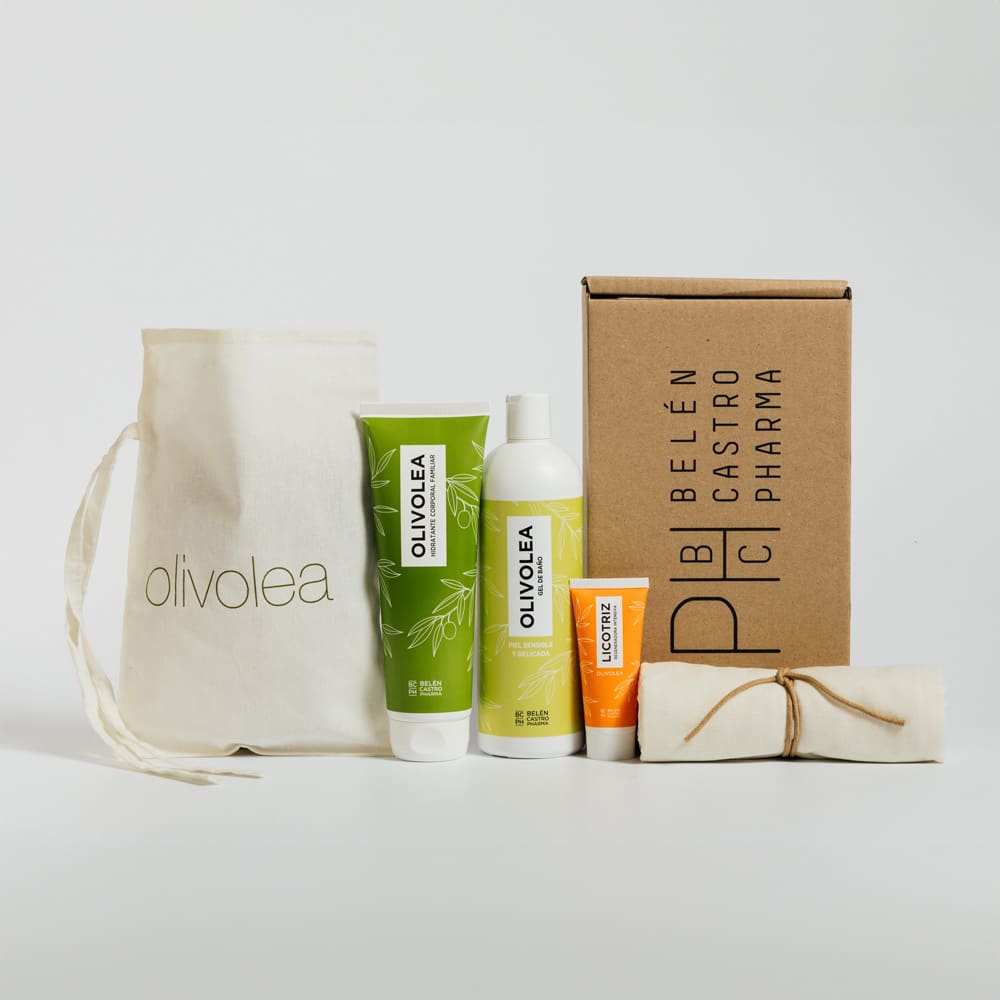 Set de productos OLIVOLEA con crema, loción y gel en envases verdes y naranjas junto a bolsa Belén Castro Pharma