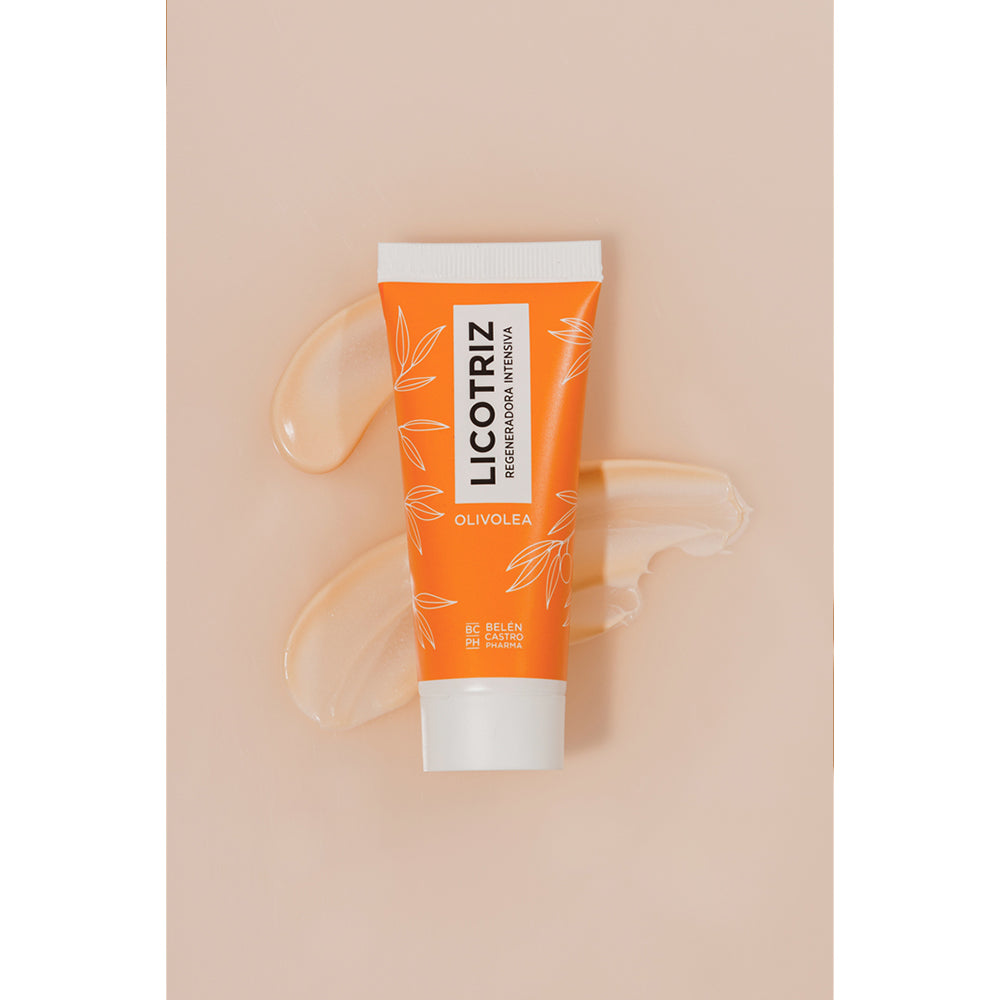 Envase de crema Olivolea regeneradora intensiva en color naranja rodeado de gotas de producto sobre superficie clara